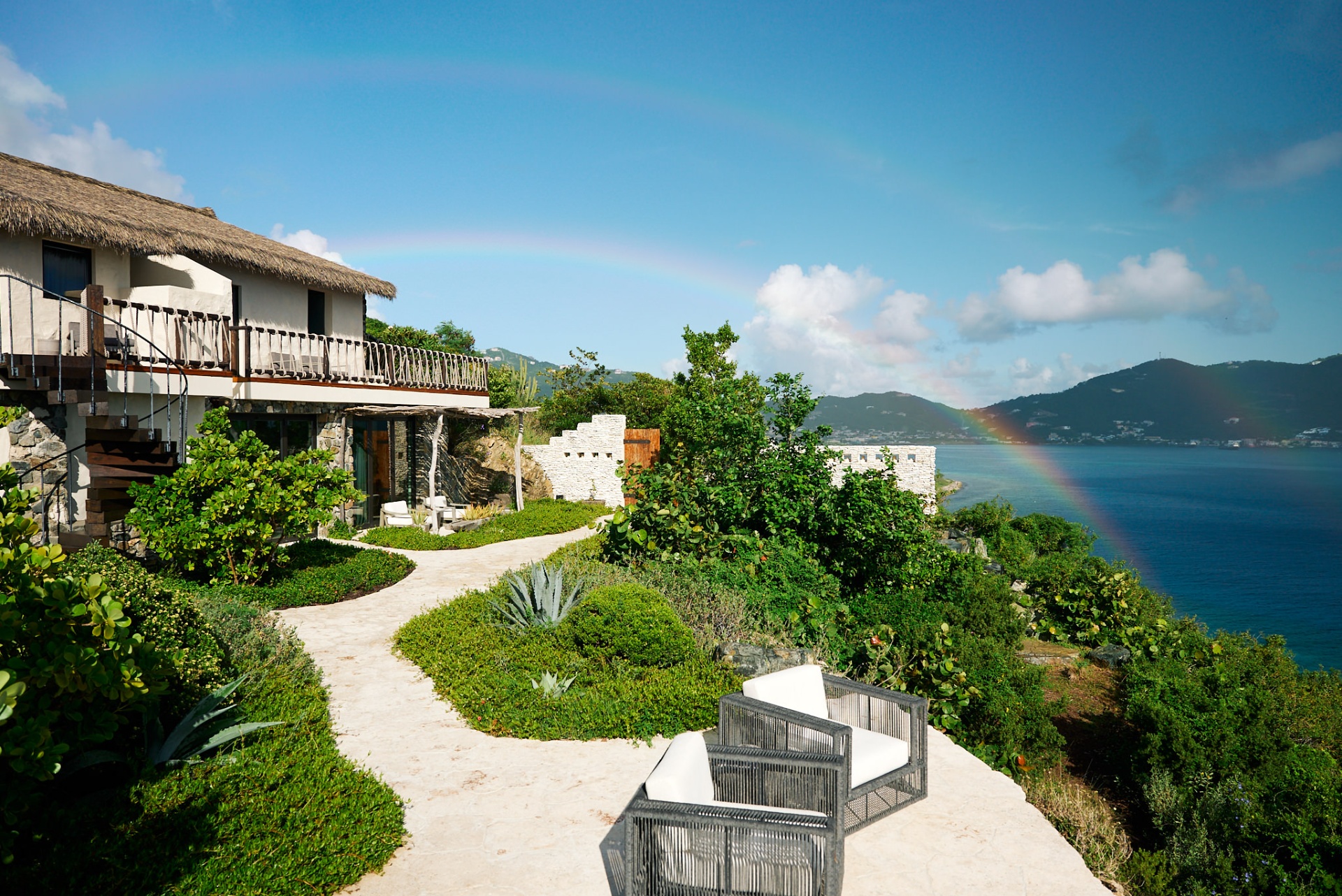 Clifftop villa with rainbow over the Caribbean