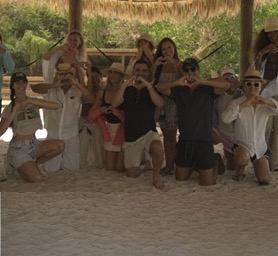 Summit community posing together on the beach