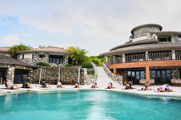 Wellness practice at sunrise beside the infinity pool